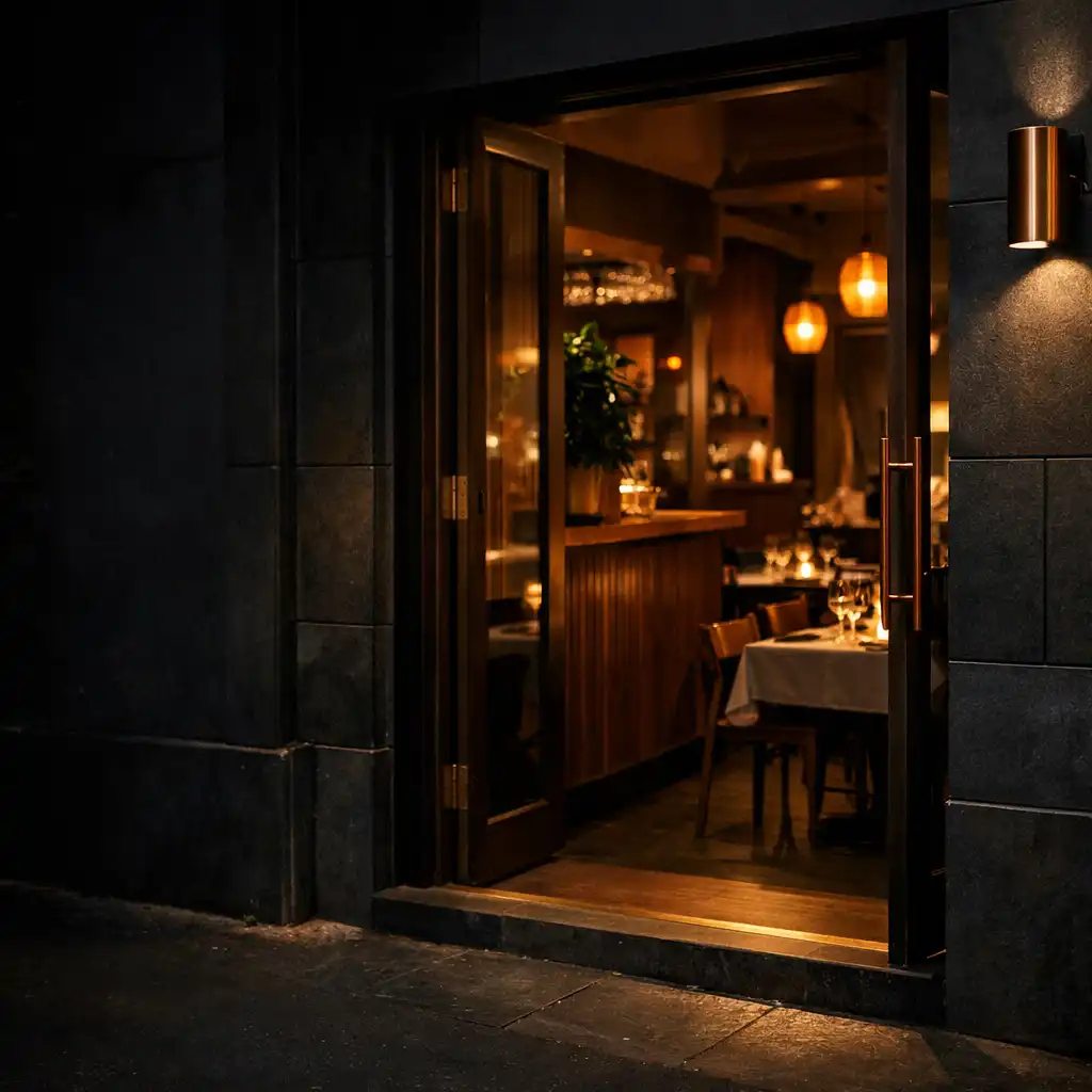 Warmly lit bistro entrance at night